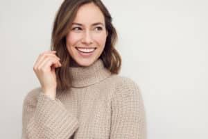 A woman smiling after getting BOTOX® Cosmetic for a gummy smile